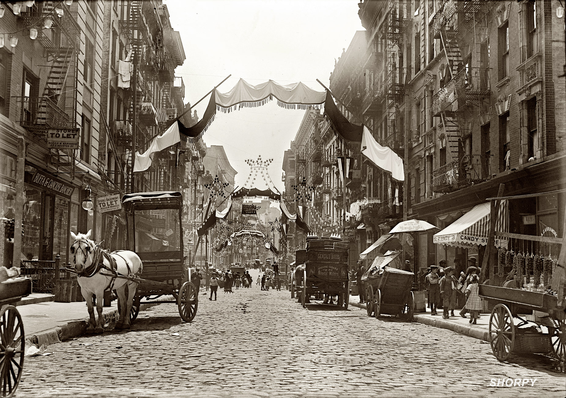 Mott Street all fancied up for a religious festival in 1908. It's May 16, so perhaps Ascension Day? (Cleaned up picture courtesy Shorpy)
