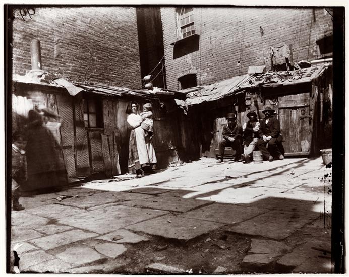 1897 Yard in Jersey Street (now gone). A woman holding a child, and men sitting in a rear yard of a Jersey Street tenement. Pietro lived on Jersey Street and one of these buildings may have been his home.