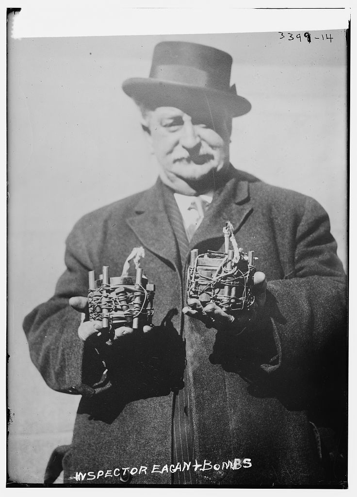 Owen Eagan (1957-1920), a bomb expert in the New York City Fire Department's Bureau of Combustibles. He is holding a bomb recovered from an attempted anarchist bombing of St. Patrick's Cathedral, New York City on March 2, 1915. (Source: Flickr Commons project and New York Times, March 3, 1915) Forms part of: George Grantham Bain Collection (Library of Congress).