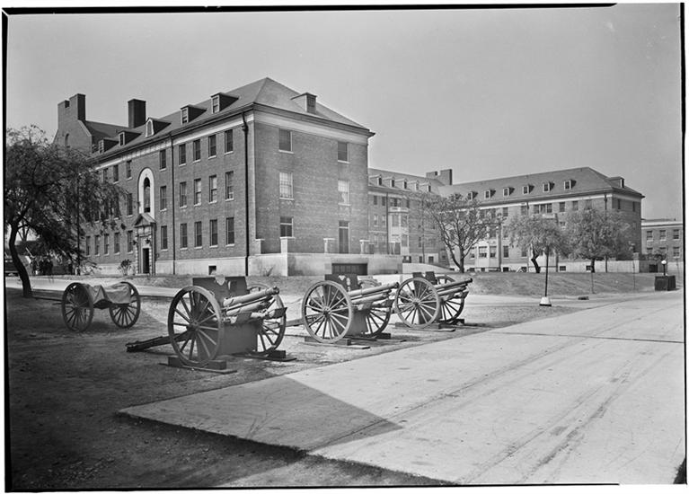 Photo by Samuel H. (Samuel Herman) Gottscho.  Officer's apartments, Governors Island, N.Y. 3/4 view cannon foreground. Courtesy Museum of the City of New York